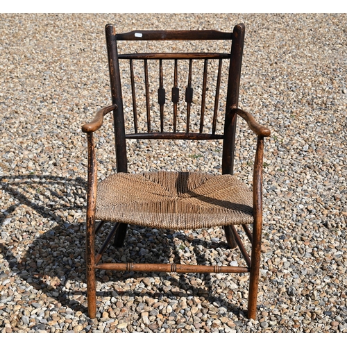 536 - An antique provincial spindle back elbow chair with rush seat