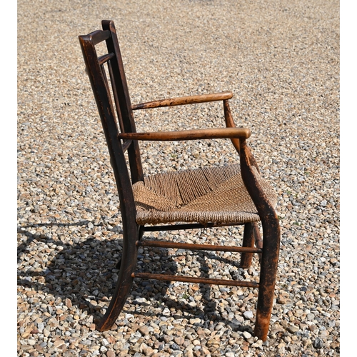 536 - An antique provincial spindle back elbow chair with rush seat