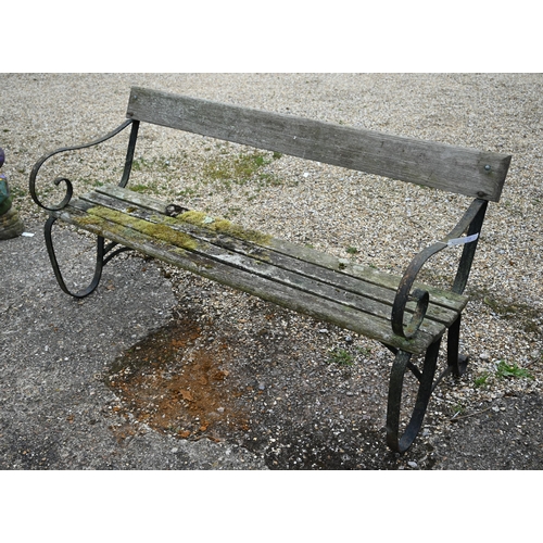 7 - A weathered wood slat and wrought iron framed garden bench, 166 cm w - a/f