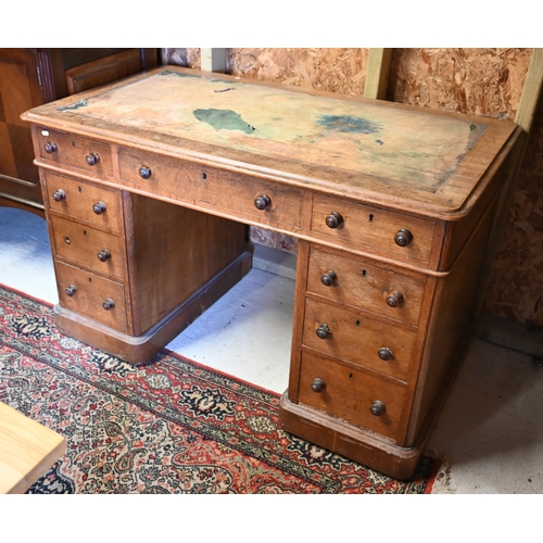 86 - A Victorian oak twin pedestal desk, with nine drawers, raised on plinths and concealed castors - as ... 