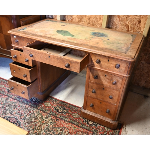 86 - A Victorian oak twin pedestal desk, with nine drawers, raised on plinths and concealed castors - as ... 