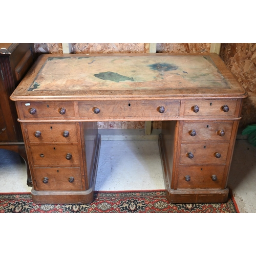 86 - A Victorian oak twin pedestal desk, with nine drawers, raised on plinths and concealed castors - as ... 