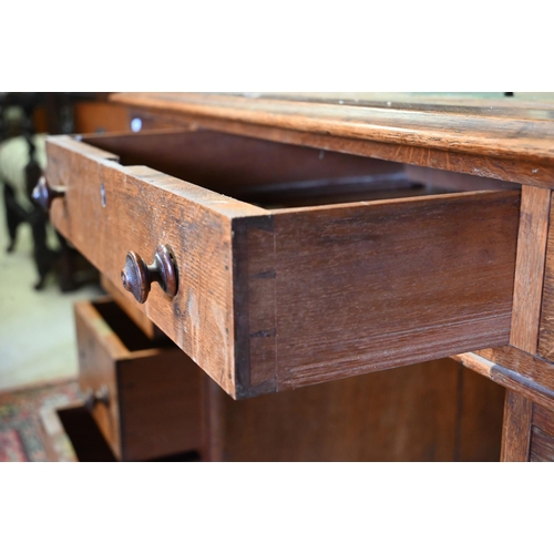 86 - A Victorian oak twin pedestal desk, with nine drawers, raised on plinths and concealed castors - as ... 