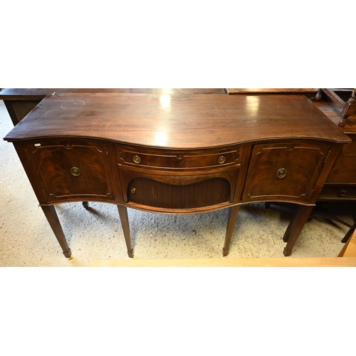 94 - A mahogany serpentine front sideboard, centred by a frieze drawer over a tambour cupboard flanked by... 