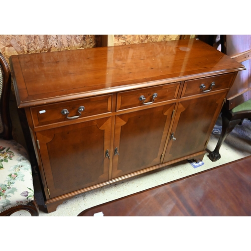 96 - # A reproduction yew three drawer over three cupboard sideboard, 122 cm x 45 cm x 81 cm h