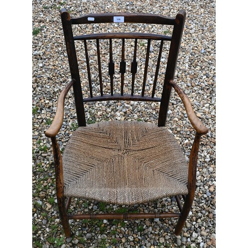 536 - An antique provincial spindle back elbow chair with rush seat