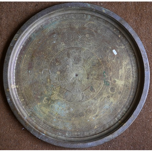 237 - Four large Eastern copper circular trays with engraved decoration