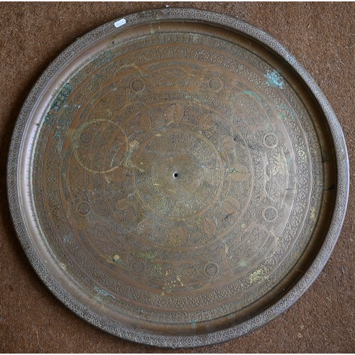 237 - Four large Eastern copper circular trays with engraved decoration