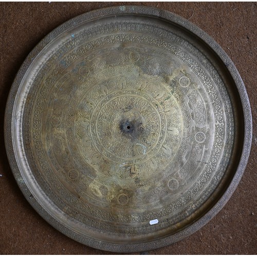 237 - Four large Eastern copper circular trays with engraved decoration