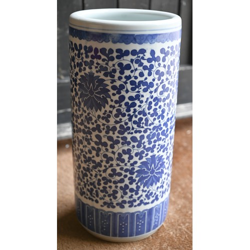 138 - A Chinese blue and white ceramic cylindrical stick-stand with floral and foliate decoration, 46 cm h... 