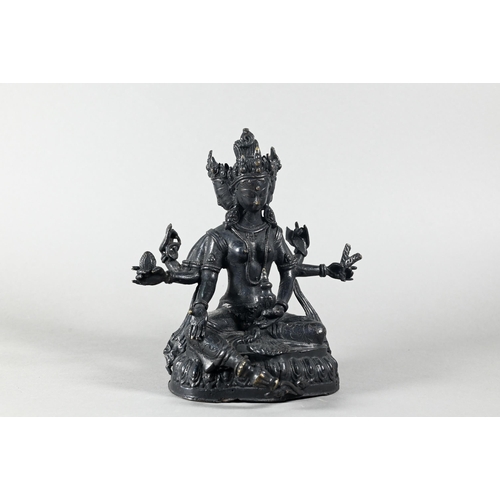 443 - A Nepalese bronze figure of the three-faced Buddhist goddess Vasudhara, seated in royal ease positio... 