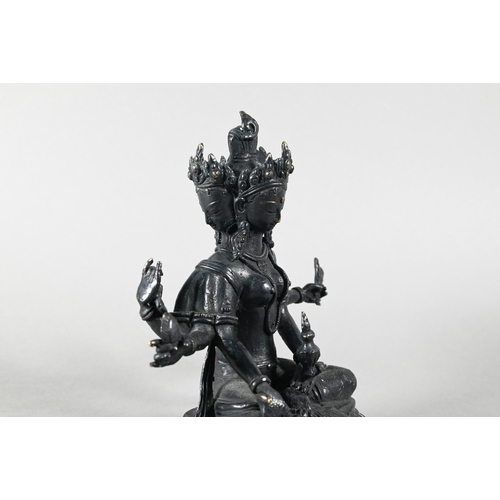 443 - A Nepalese bronze figure of the three-faced Buddhist goddess Vasudhara, seated in royal ease positio... 