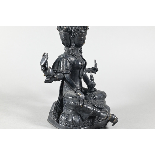 443 - A Nepalese bronze figure of the three-faced Buddhist goddess Vasudhara, seated in royal ease positio... 