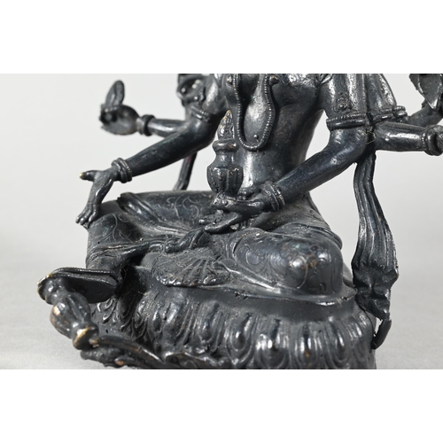 443 - A Nepalese bronze figure of the three-faced Buddhist goddess Vasudhara, seated in royal ease positio... 