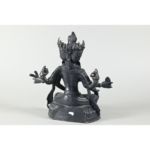 443 - A Nepalese bronze figure of the three-faced Buddhist goddess Vasudhara, seated in royal ease positio... 