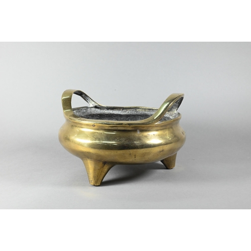 450 - A large 19th century Chinese bronze tripod censer, compressed globular form with loop handles standi... 