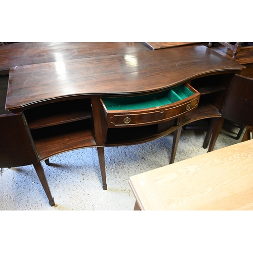 560 - #A mahogany serpentine front sideboard, centred by a frieze drawer over a tambour cupboard flanked b... 