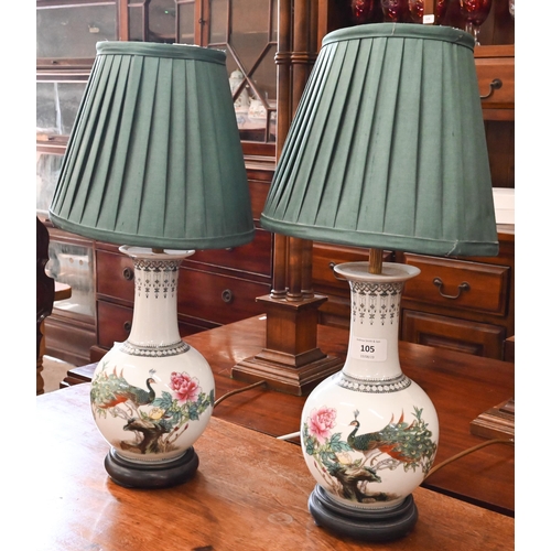 105 - A pair of Chinese ceramic baluster table lamps decorated with peacocks in the famille rose manner, 2... 