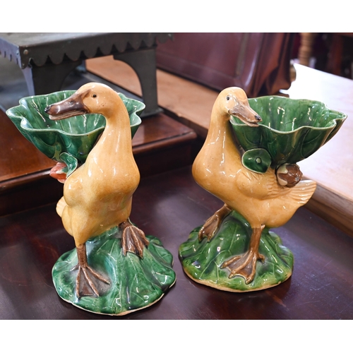 109 - A pair of Chinese glazed pottery ducks supporting leaf bowls, 21 cm max