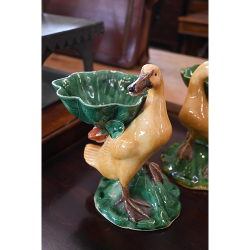 109 - A pair of Chinese glazed pottery ducks supporting leaf bowls, 21 cm max