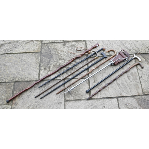 118 - A shooting stick and bundle of walking sticks