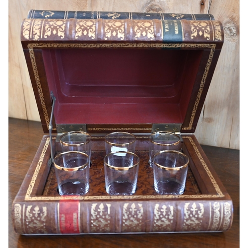 127 - A simulated stack of three leather-bound books, enclosing a set of six shot-glasses, to/w a bronzed ... 