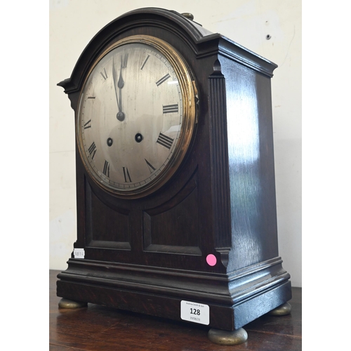 128 - A French oak bracket clock with silvered dial, striking on a coiled gong, 44 cm high