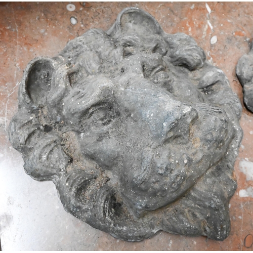 130 - A pair of cast lead lion-masks, 22 cm high