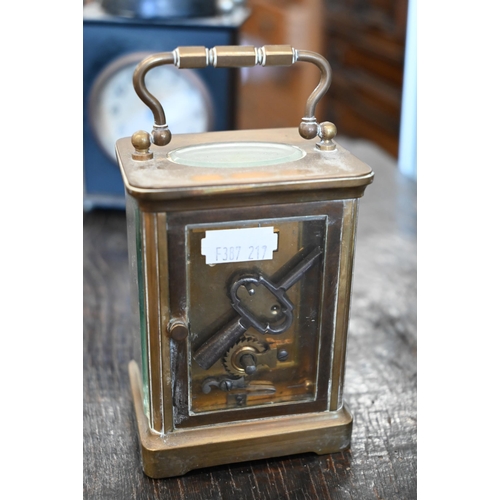 132 - A French brass carriage clock, 15 cm high overall, to/w an American painted tin alarm clock (2)