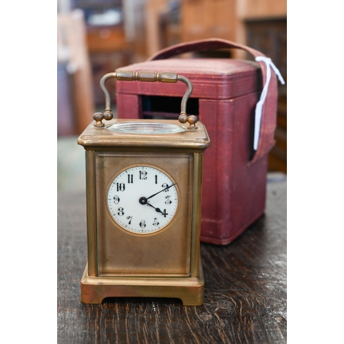 133 - A brass carriage clock, 14.5 cm high, in red leather case