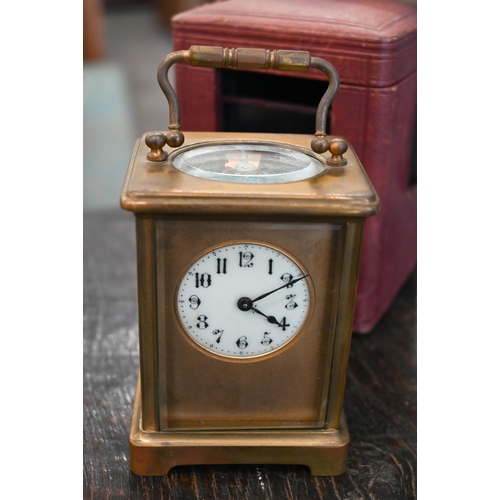 133 - A brass carriage clock, 14.5 cm high, in red leather case