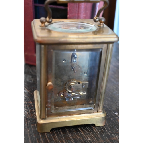 133 - A brass carriage clock, 14.5 cm high, in red leather case