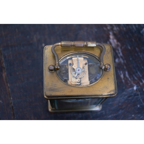 133 - A brass carriage clock, 14.5 cm high, in red leather case