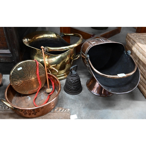 174 - Two Victorian coal helmets in copper and brass to/w a preserving pan and dinner gong (4)