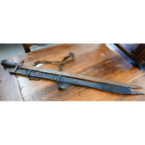 179 - A 19th Century Sudanese Kaskara sword with 90cm two-edged blade and wooden hilt, in chased leather s... 