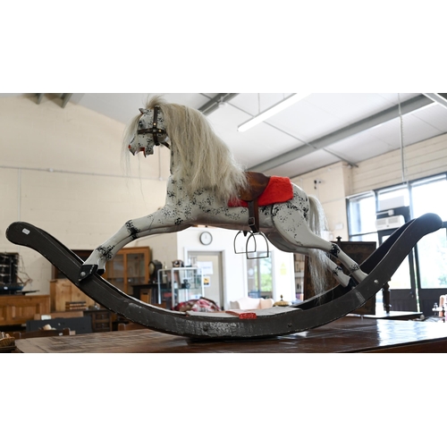 198 - A painted dapple-grey rocking horse of Victorian origin (restored), base 160 cm long