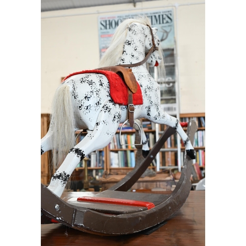 198 - A painted dapple-grey rocking horse of Victorian origin (restored), base 160 cm long