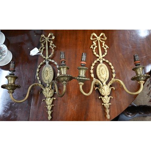 215 - A pair of Adam-style gilt metal twin-branch wall-lights, 45 cm high