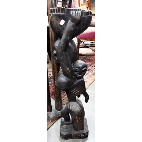 217 - An Egyptian carved wood elongated camel figure, 154 cm to/w a carved wood female figure pedestal (2)