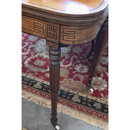 219 - A 19th century mahogany and ebony strung card table with folding baize lined top on turned and reede... 