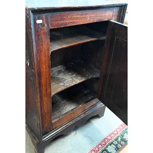 221 - An antique Provincial oak side cabinet on stand with single panelled door enclosing shelves, 60 x 35... 