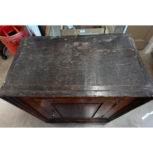 221 - An antique Provincial oak side cabinet on stand with single panelled door enclosing shelves, 60 x 35... 