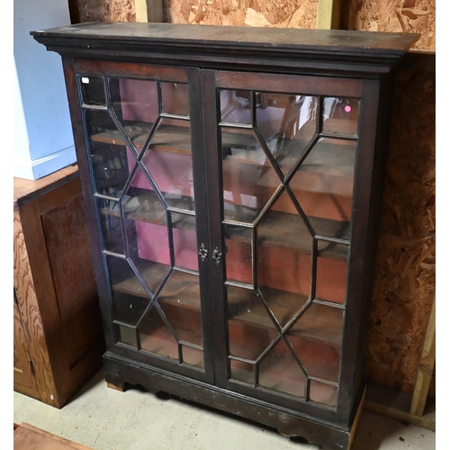 545 - #An antique oak bookcase with astragal glazed doors enclosing three adjustable shelves, 102 cm wide ... 