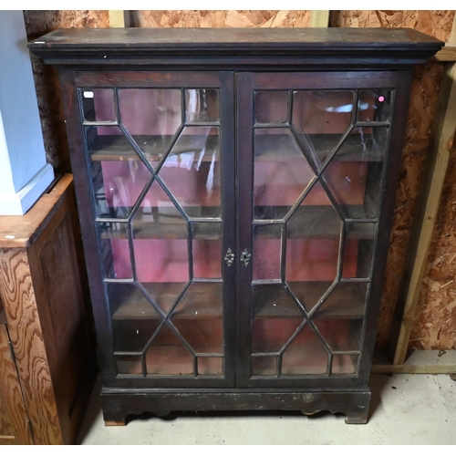 545 - #An antique oak bookcase with astragal glazed doors enclosing three adjustable shelves, 102 cm wide ... 