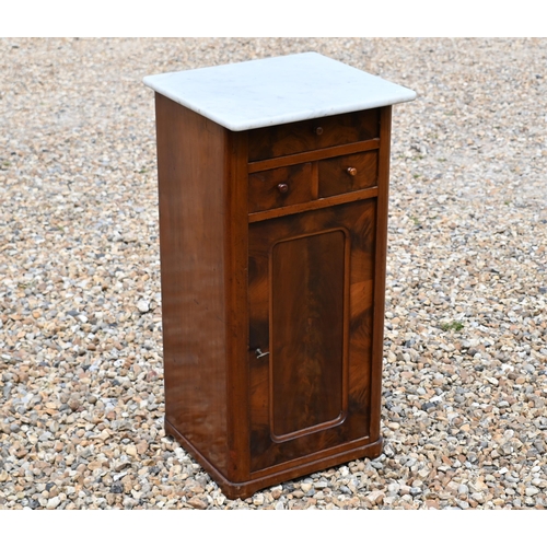 553 - A 19th century marble top bedside cabinet with three drawers over panelled cupboard door, 40 cm wide... 