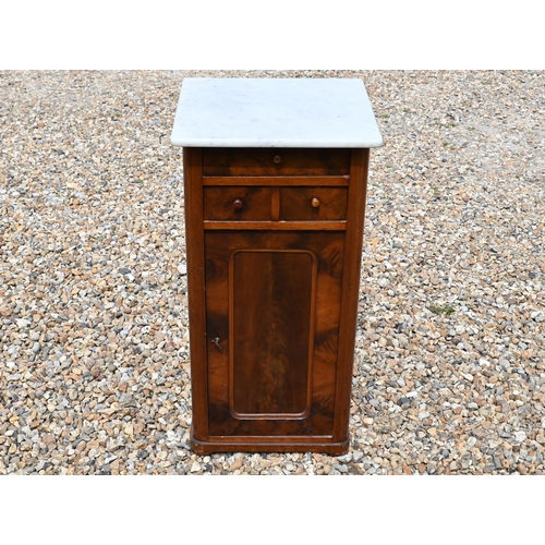 553 - A 19th century marble top bedside cabinet with three drawers over panelled cupboard door, 40 cm wide... 