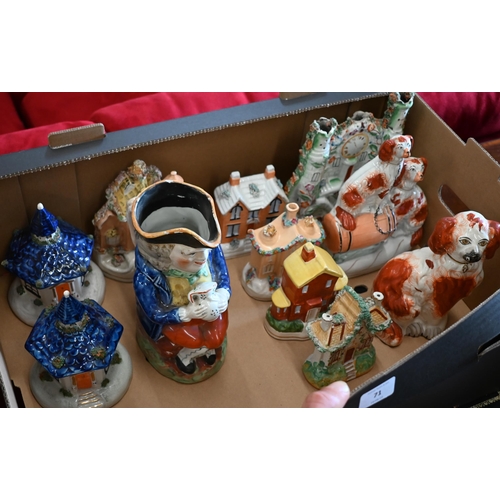 71 - An antique Staffordshire pottery Toby jug, seven cottages, a spaniel and two spaniel ornaments