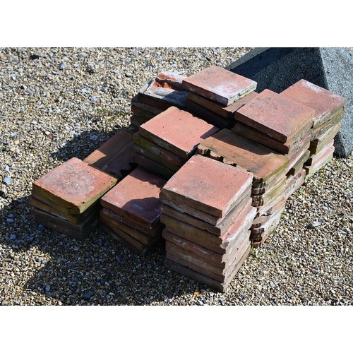 49 - A quantity of old terracotta square tiles, 23 x 23 cm and nineteen crenalated edging tiles