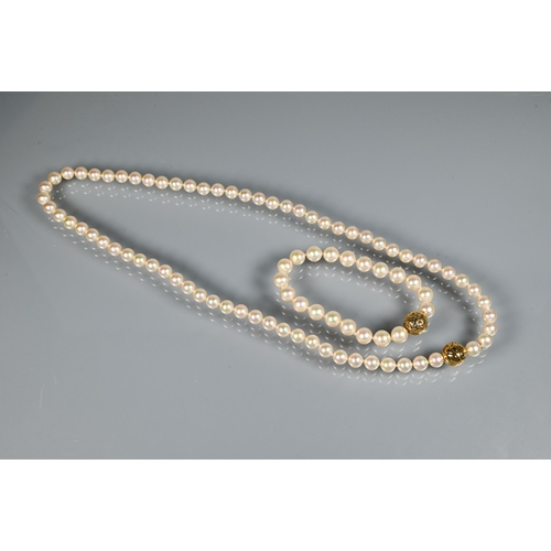 303 - Majorica - A uniform cultured pearl necklace double knotted throughout onto pierced bead-style snap ... 