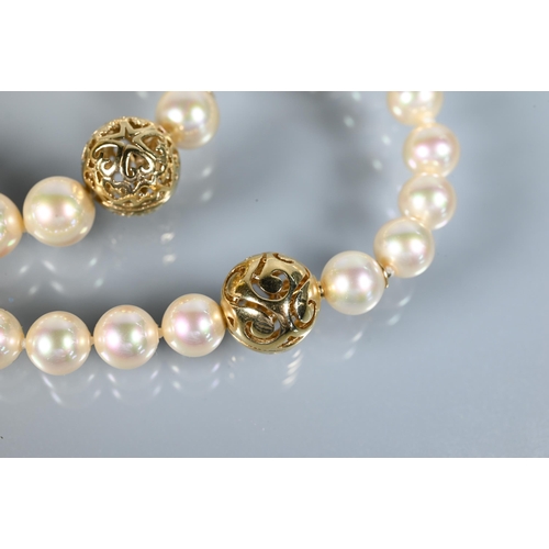 303 - Majorica - A uniform cultured pearl necklace double knotted throughout onto pierced bead-style snap ... 